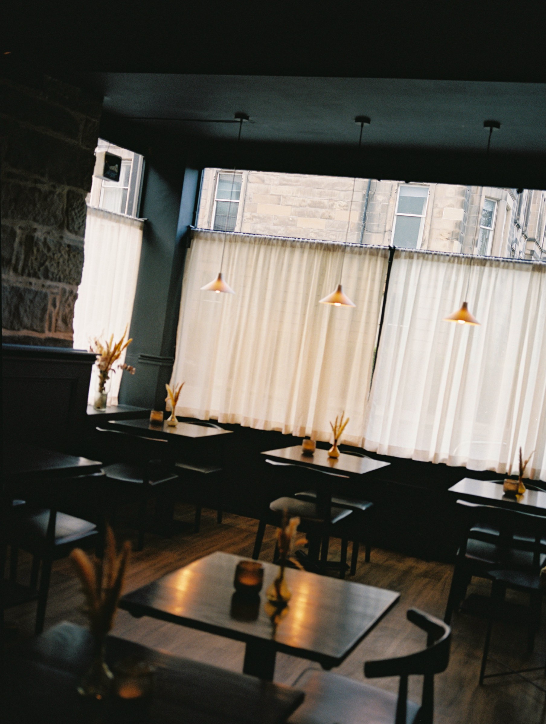 The Cardinal dining room, tables in rows beneath the lamps